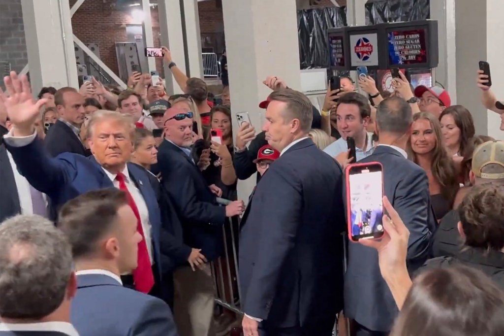 Trump greeted by chants of ‘USA,’ tosses popcorn to fans as he attends Alabama vs. Georgia football game