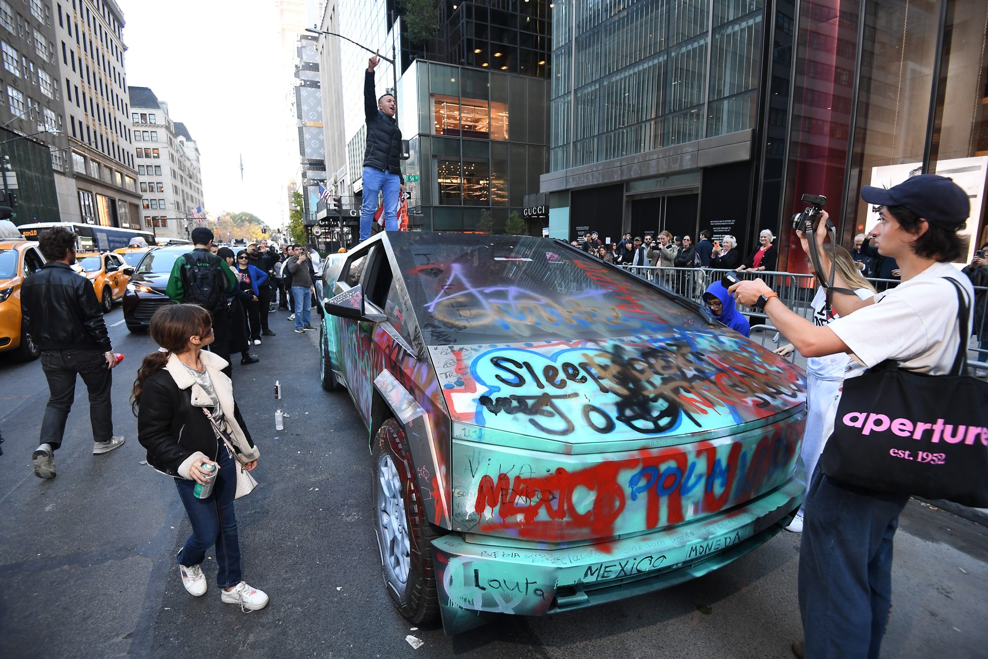 Trump supporters get rowdy outside Trump Tower in Midtown, dance on Tesla Cybertruck during Election Day