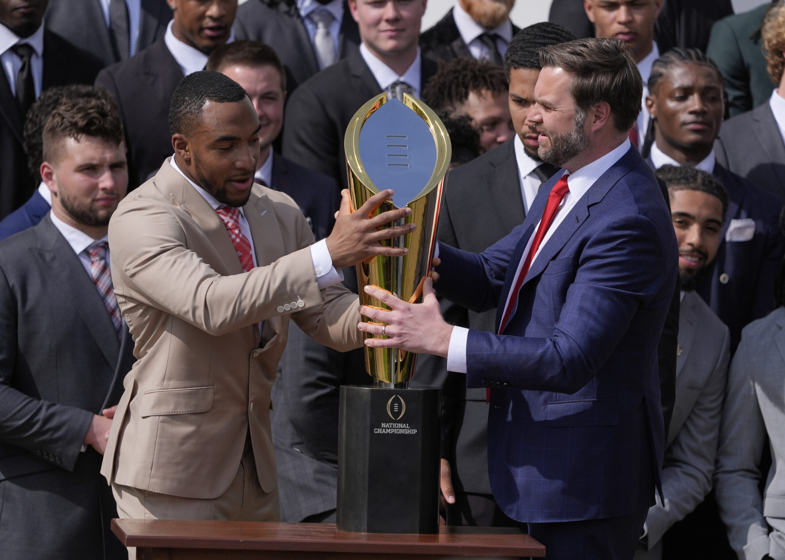 VP JD Vance fumbles Ohio State’s national championship trophy, jokes about not wanting other teams to win it: ‘Decided to break it’