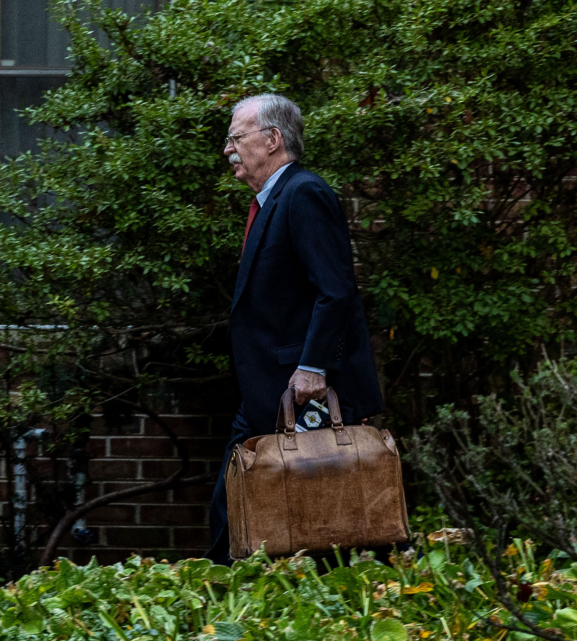 John Bolton spotted still using White House bag tag as he surrenders in classified documents case