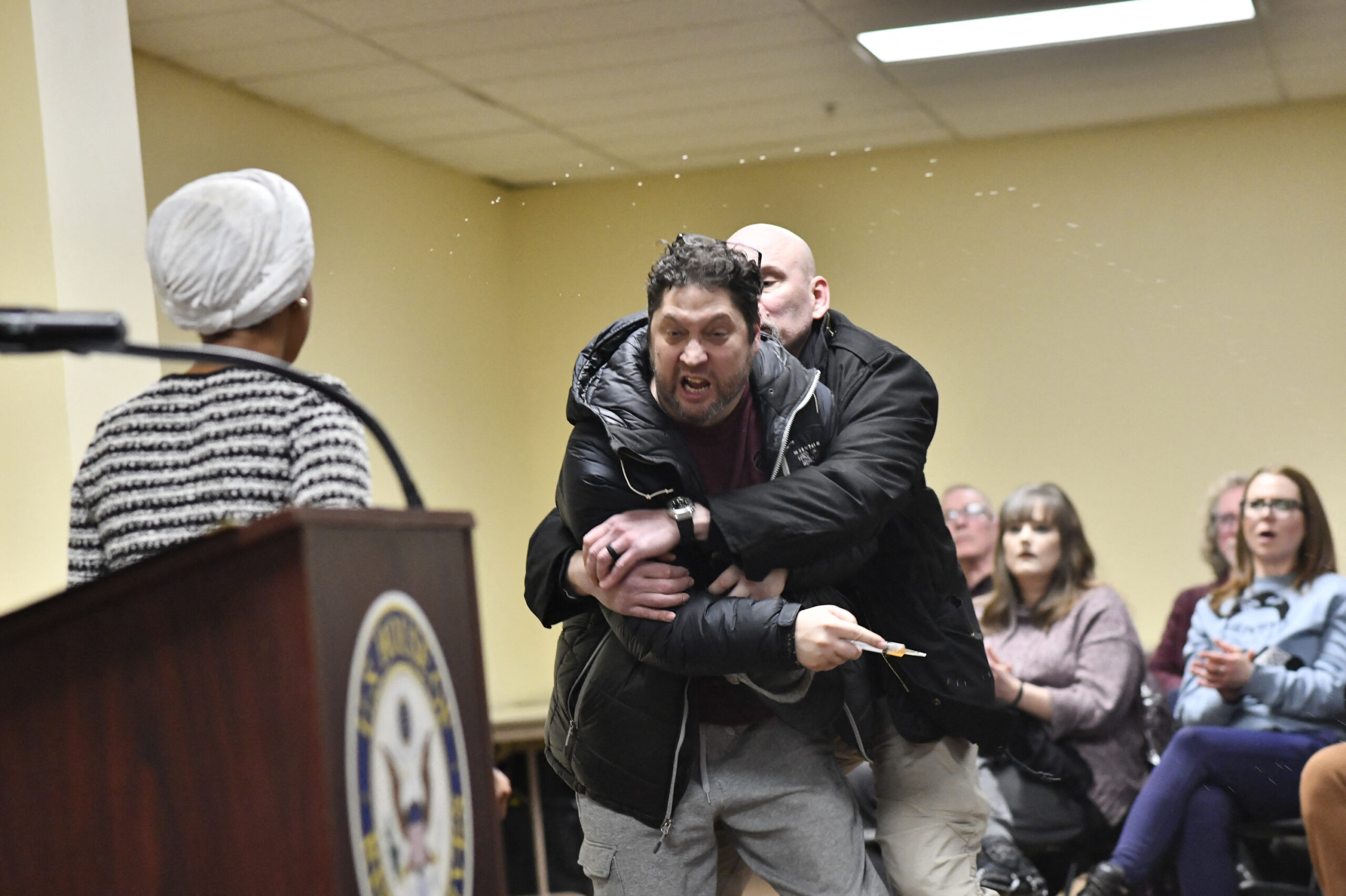 Rep. Ilhan Omar sprayed with unknown substance in syringe by ranting audience member at chaotic town hall